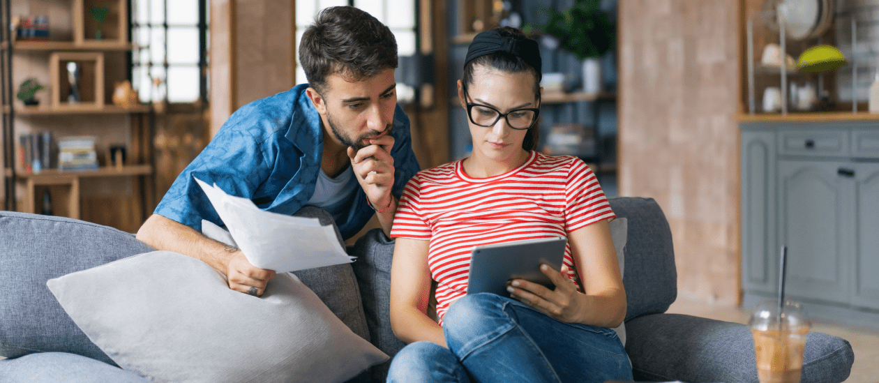 Couple looking over solar loan on a tablet